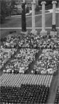 Aerial Shot of Seated Graduates and Audience near Columns
