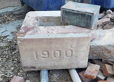 Parker Hall cornerstone and its time capsule during demolition in 2022