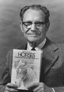 C. Melvin Bradley with a copy of his 1981 textbook