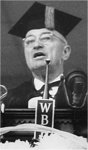Truman Speaks at Podium, into Several Microphones