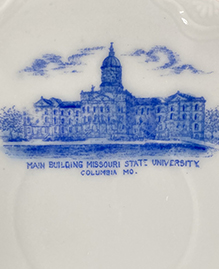 Detail depicting the main building of the University of Missouri - then still referred to as Missouri State University -- from a small china saucer made in Austria and sold by the Gant Brothers who owned a grocery store in Columbia around the turn of the 19th century.