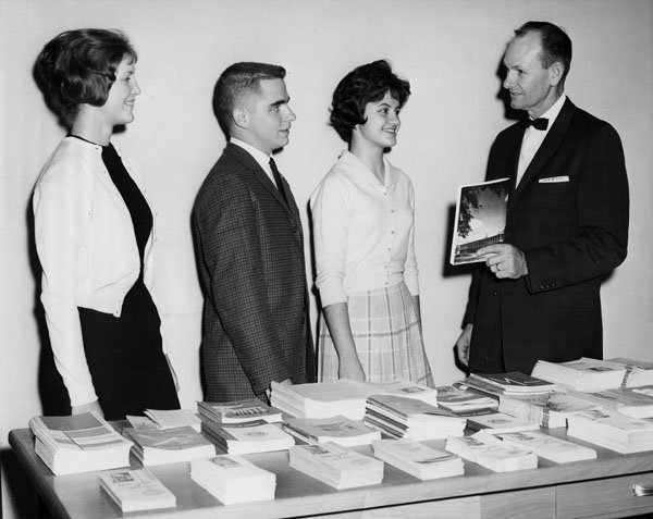 Allan Purdy and students with financial aid brochures, n.d.