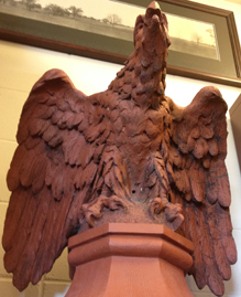 The terracotta eagle that once perched atop a gable of Lathrop Hall, now rests in the Reading Room of University Archives at the University of Missouri.