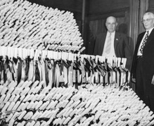 University of Missouri President Frederick Middlebush and Senator Allen McReynolds standing next to the diplomas for the 1949 Commencement ceremonies