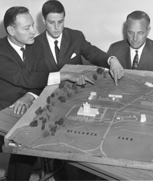 Chancellor John Schwada inspects model of Research Park development.